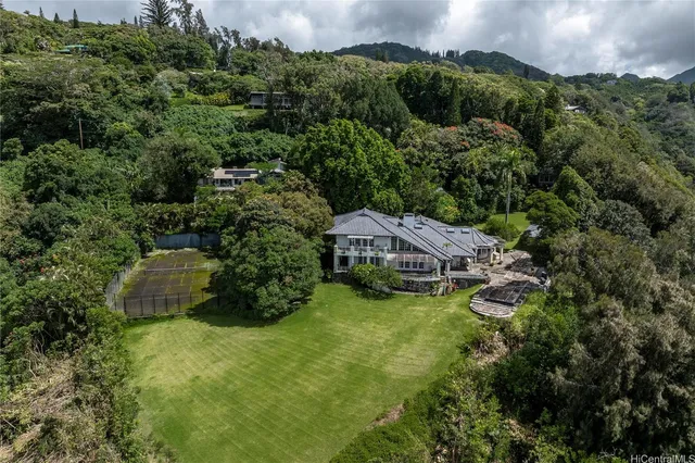 an aerial view of a house with a yard and lake view