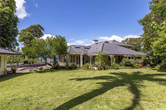 a backyard of a house with yard and outdoor seating