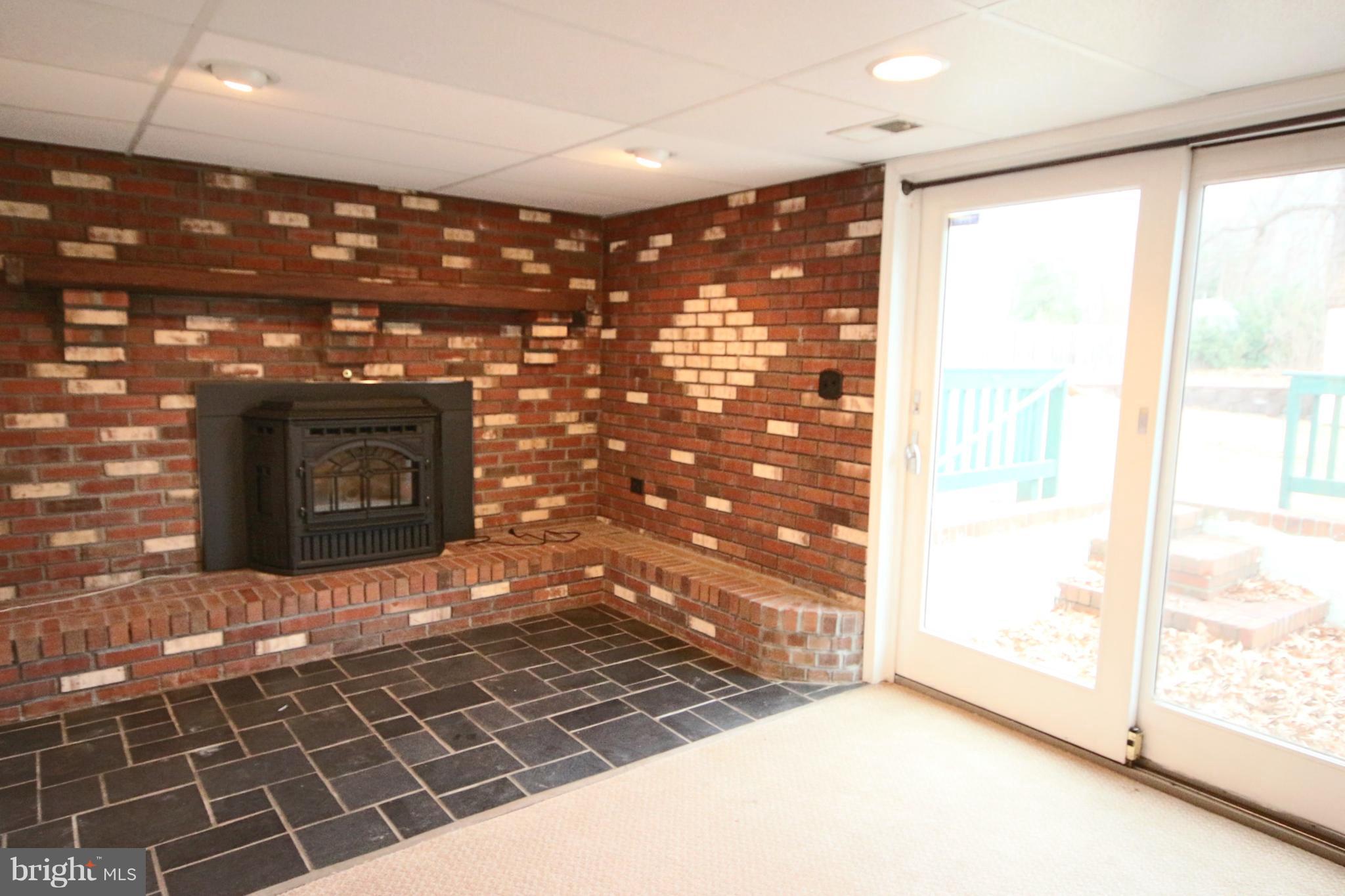 1586 Long Point Road Pasadena, MD 21122 - Photo 13 of 23 Family Room Pellet Stove