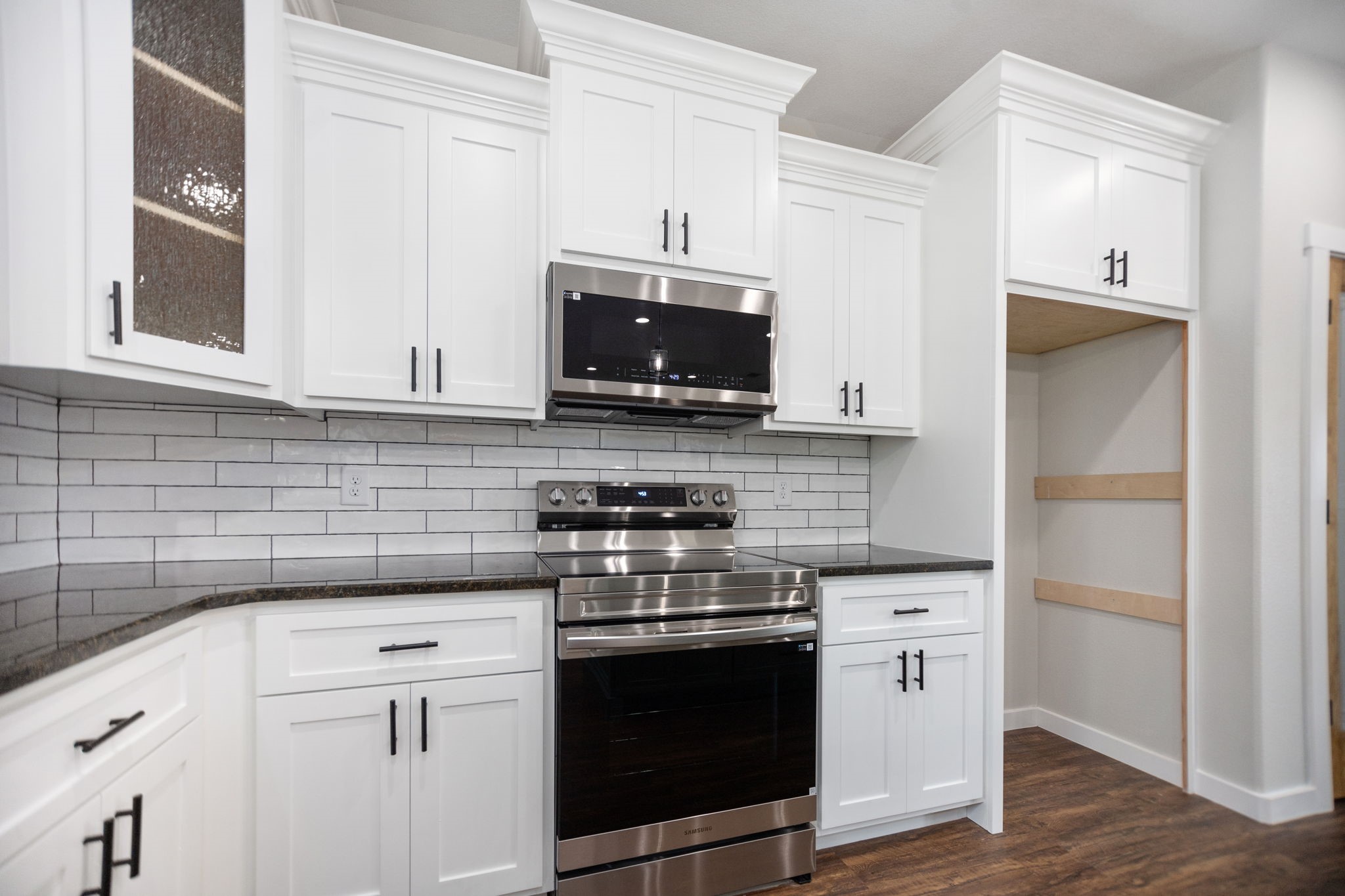 1575 Fm 844 Huntington, TX 75949 - Photo 17 of 40 a kitchen with stainless steel appliances granite countertop a stove microwave and refrigerator