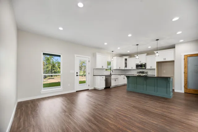 a bathroom with a granite countertop sink toilet a mirror and shower