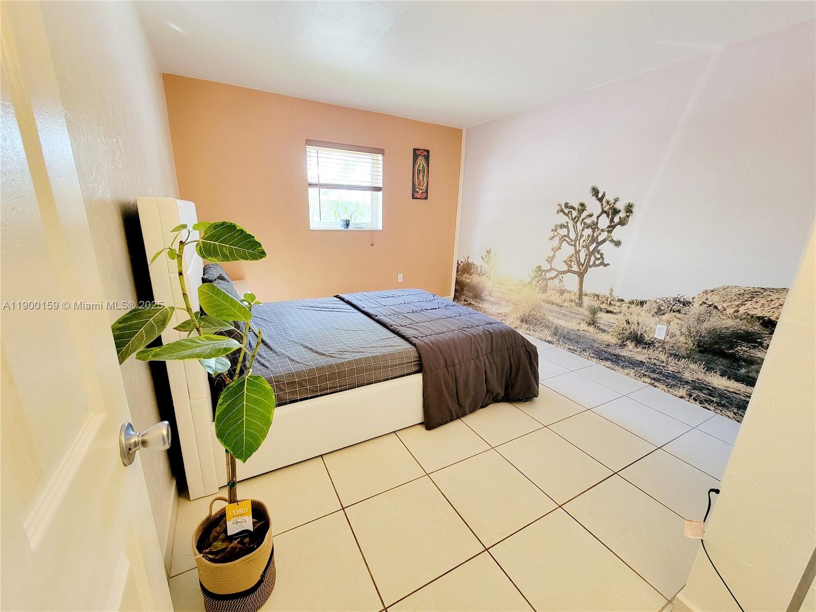 8609 Southwest 68th Court, Unit 5 Pinecrest, FL 33156 - Photo 12 of 35 a bedroom with a bed and a chandelier