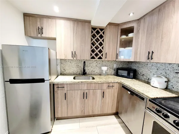 a kitchen with stainless steel appliances a sink a stove and a refrigerator