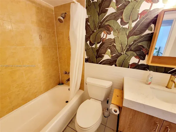 a white toilet sitting next to a bathroom sink