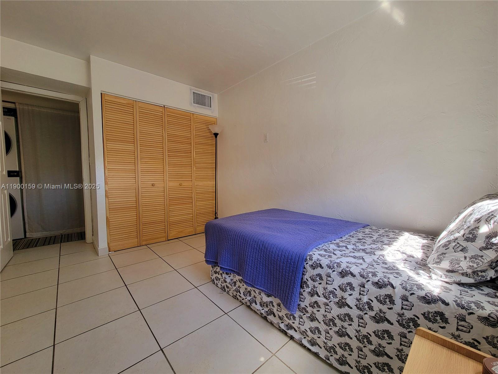 8609 Southwest 68th Court, Unit 5 Pinecrest, FL 33156 - Photo 25 of 35 a bedroom with a bed and a shower