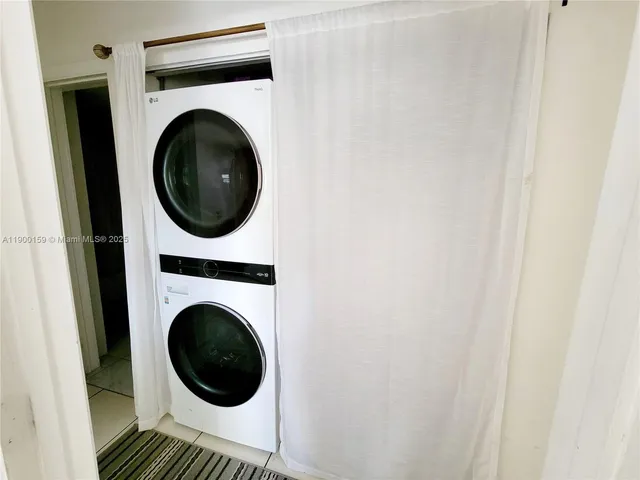 a view of a hallway with washer and dryer