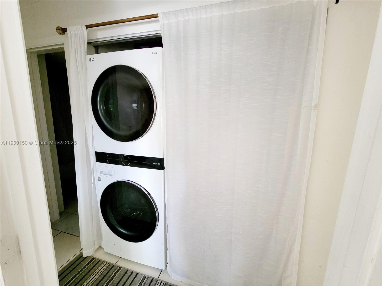 8609 Southwest 68th Court, Unit 5 Pinecrest, FL 33156 - Photo 26 of 35 a view of a hallway with washer and dryer