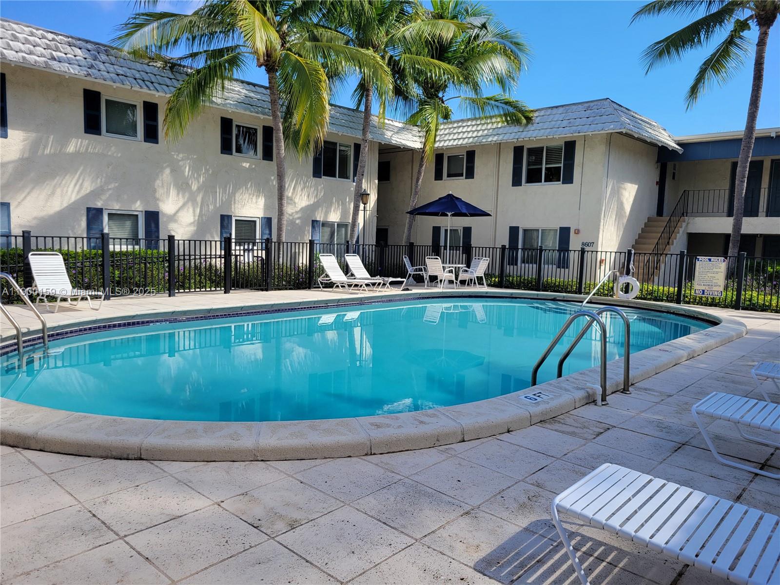 8609 Southwest 68th Court, Unit 5 Pinecrest, FL 33156 - Photo 29 of 35 a view of a house with a swimming pool