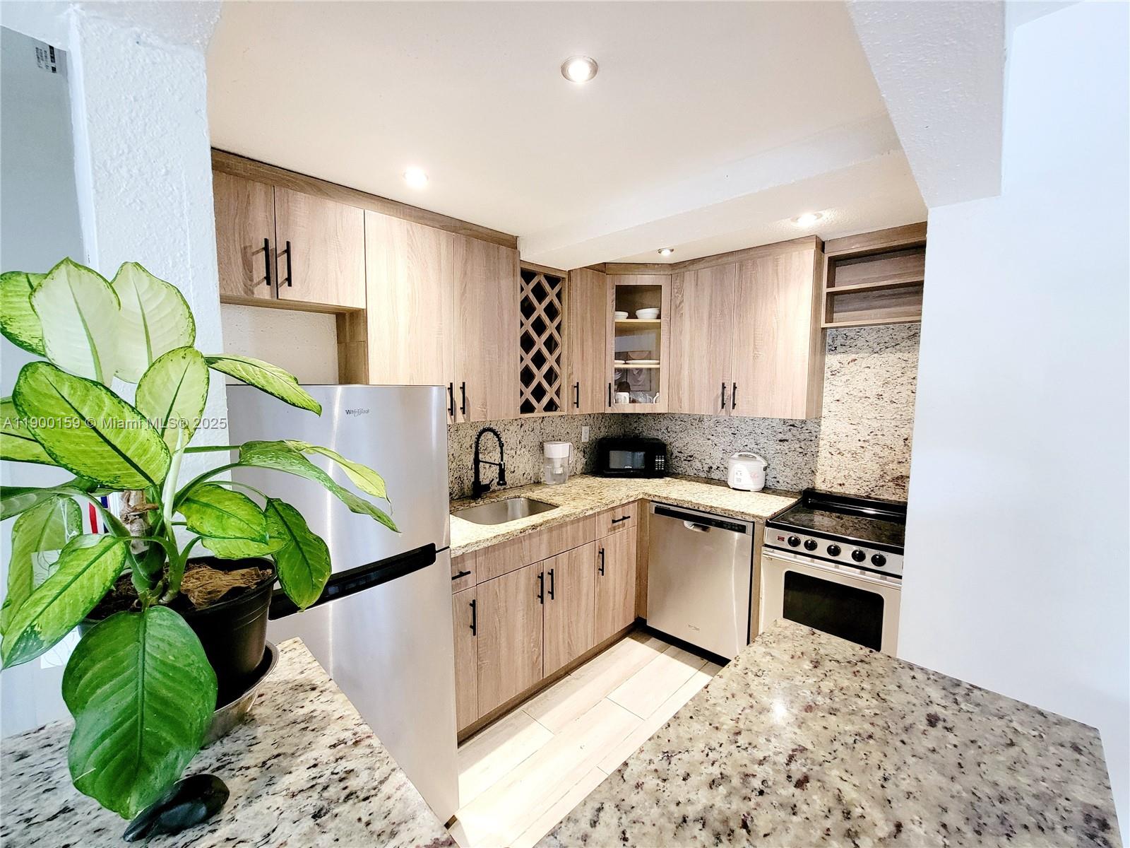 8609 Southwest 68th Court, Unit 5 Pinecrest, FL 33156 - Photo 3 of 35 a kitchen with a sink a counter top space cabinets and appliances