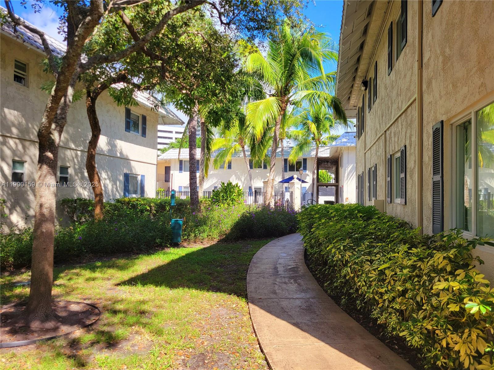 8609 Southwest 68th Court, Unit 5 Pinecrest, FL 33156 - Photo 31 of 35 a view of a garden with pathway