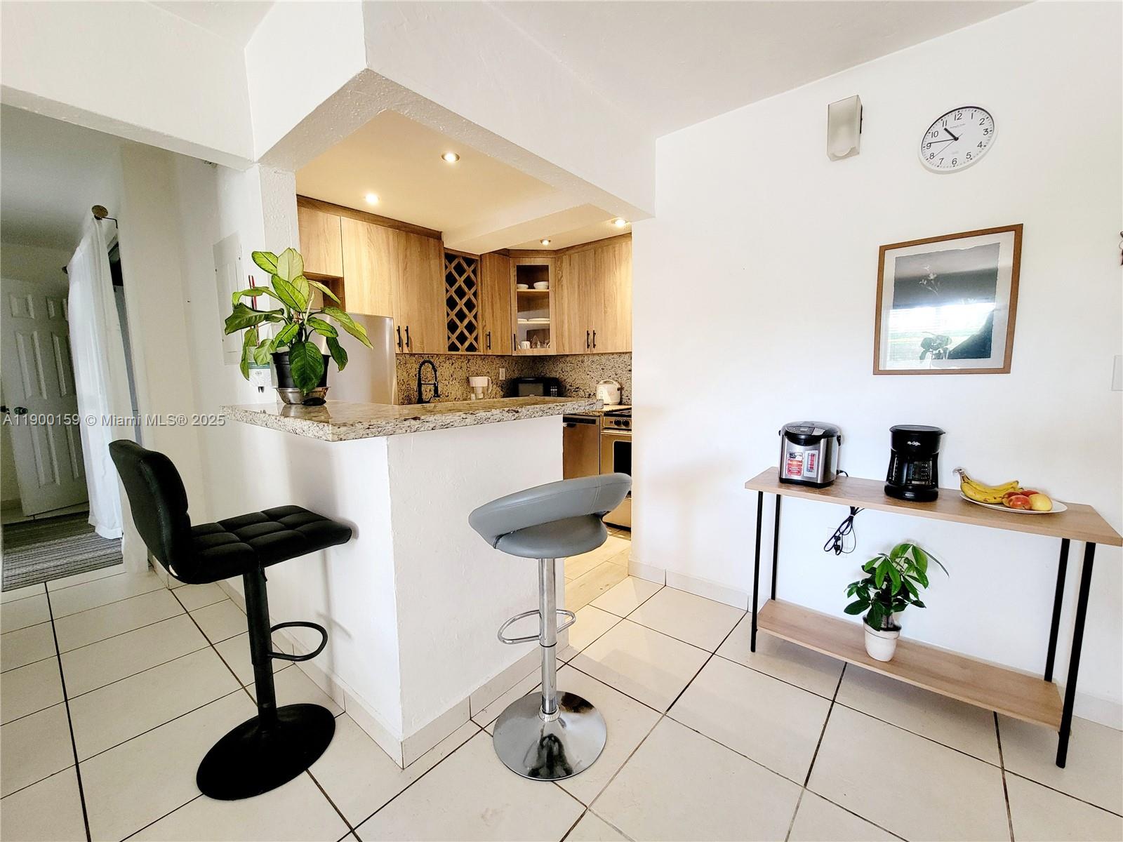 8609 Southwest 68th Court, Unit 5 Pinecrest, FL 33156 - Photo 5 of 35 a living room with furniture and a potted plant