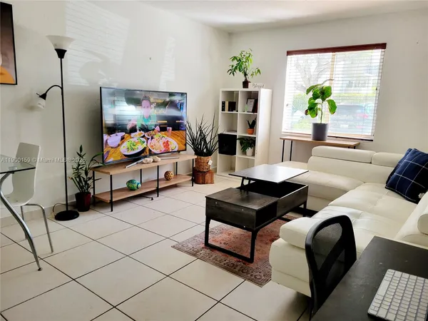 a living room with furniture and a rug