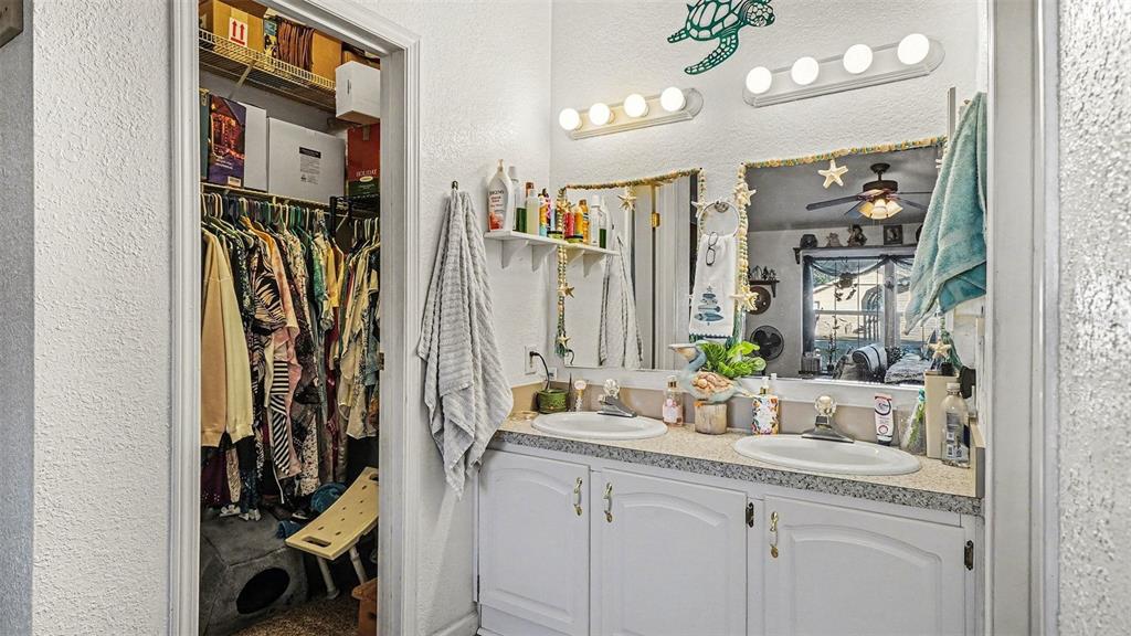 6300 East Sage Street Inverness, FL 34452 - Photo 16 of 32 a view of walk in closet with clothes and shoes