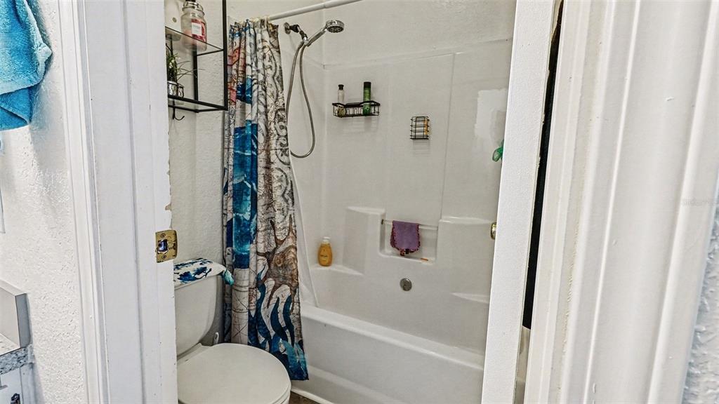 6300 East Sage Street Inverness, FL 34452 - Photo 18 of 32 a bathroom with a shower a toilet and a shower