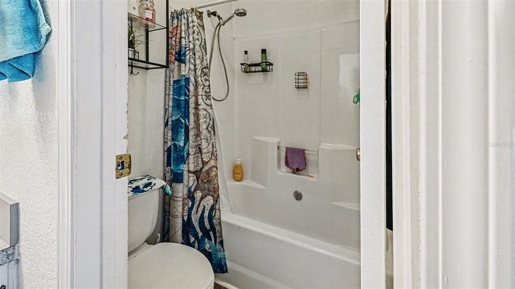 6300 East Sage Street Inverness, FL 34452 - Photo 19 of 32 a bathroom with a shower a toilet and a shower