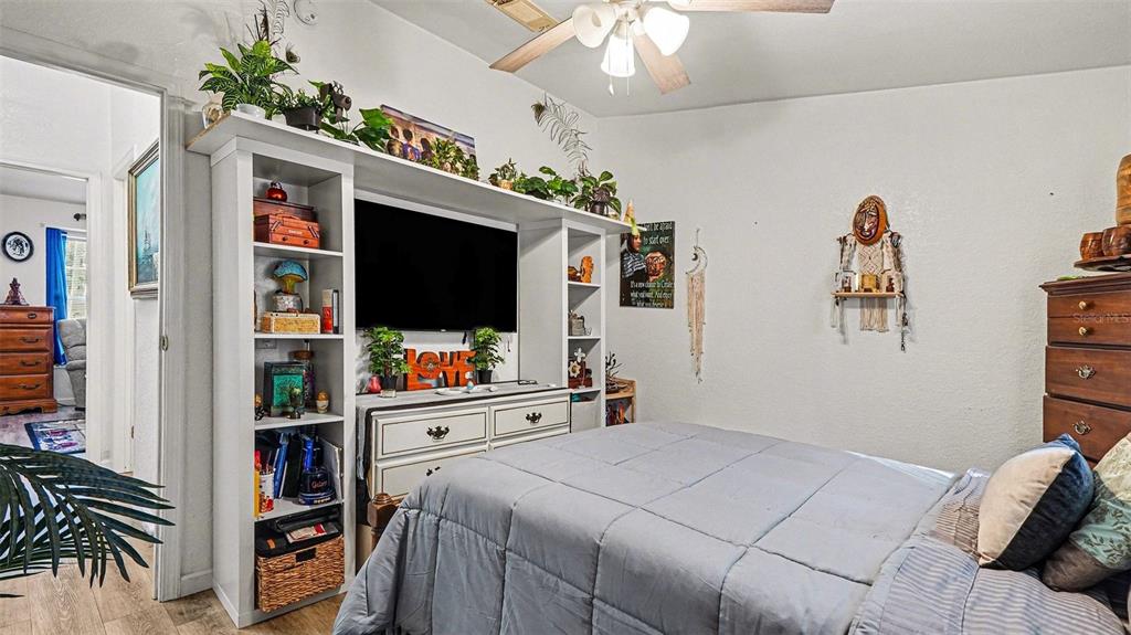 6300 East Sage Street Inverness, FL 34452 - Photo 20 of 32 a bedroom with furniture and a book shelf