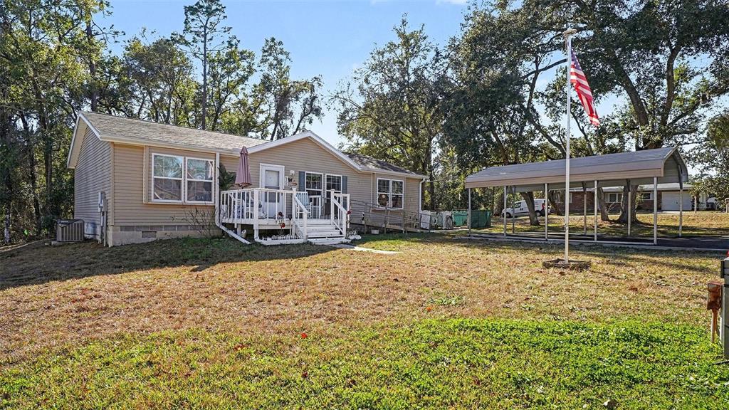 6300 East Sage Street Inverness, FL 34452 - Photo 2 of 32 a house with swimming pool in front of it