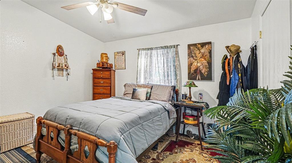 6300 East Sage Street Inverness, FL 34452 - Photo 21 of 32 a bedroom with a bed and a chandelier