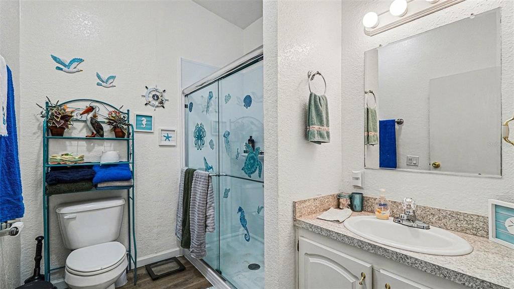 6300 East Sage Street Inverness, FL 34452 - Photo 23 of 32 a bathroom with a granite countertop sink toilet and shower