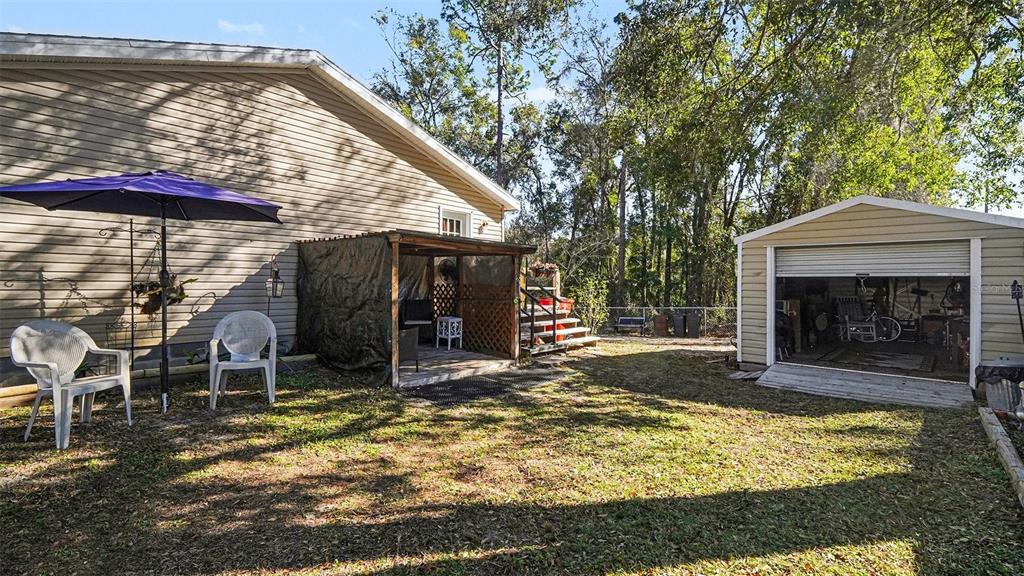 6300 East Sage Street Inverness, FL 34452 - Photo 29 of 32 a view of a house with backyard porch and sitting area