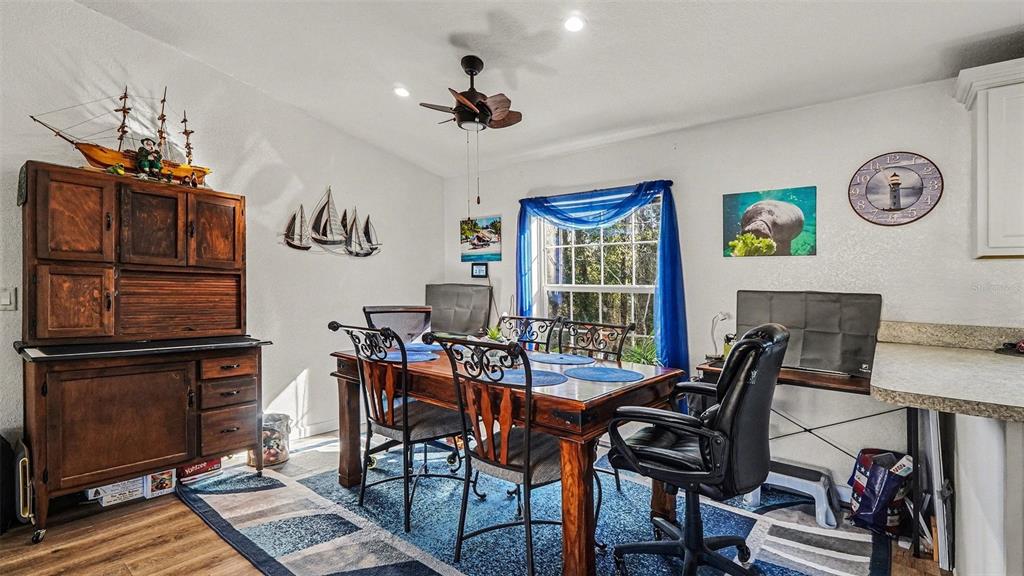 6300 East Sage Street Inverness, FL 34452 - Photo 8 of 32 a view of a dining room with furniture window and wooden floor