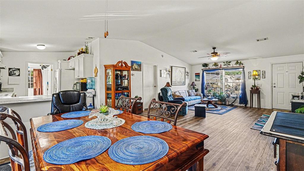 6300 East Sage Street Inverness, FL 34452 - Photo 10 of 32 a living room with furniture a wooden floor and next to a window