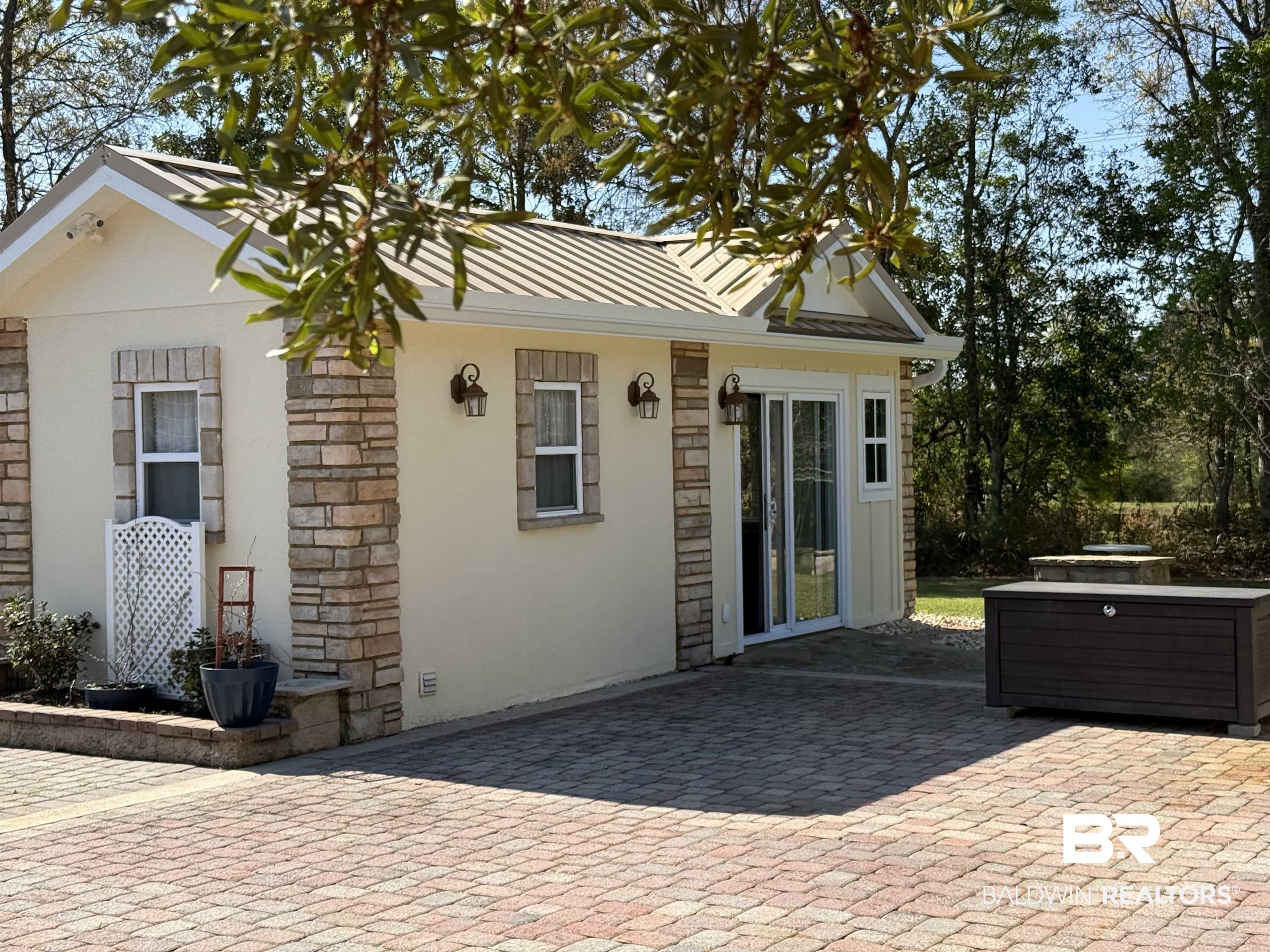 28114 Preserve Trail, Unit 190 Elberta, AL 36530 - Photo 2 of 69 View of front of property featuring a standing seam roof, stucco siding, a patio, and stone siding