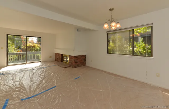 a spacious bedroom with a bed and a chandelier