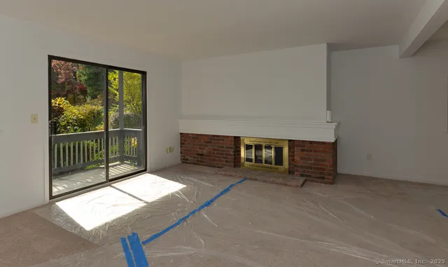 a view of a room with furniture and a window