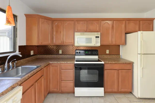 a kitchen with a stove and a refrigerator