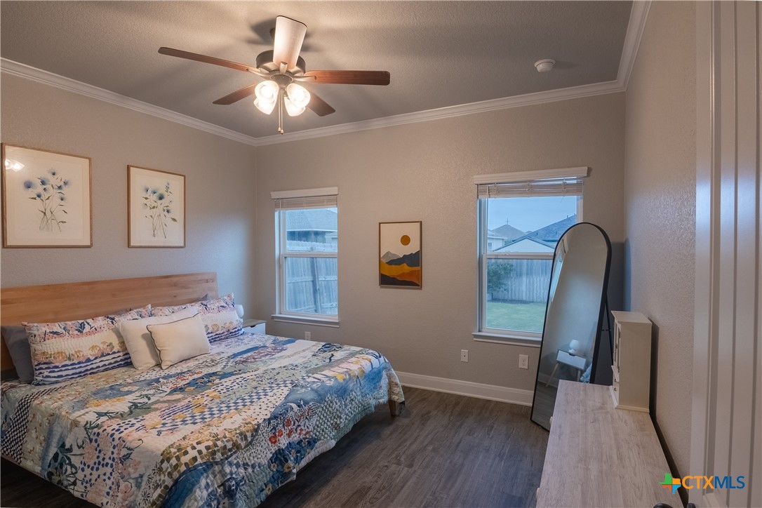 7909 McCulloch Road Temple, TX 76502 - Photo 30 of 46 a bedroom with a bed and a chandelier