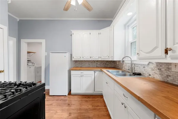 a kitchen with a sink stove and refrigerator