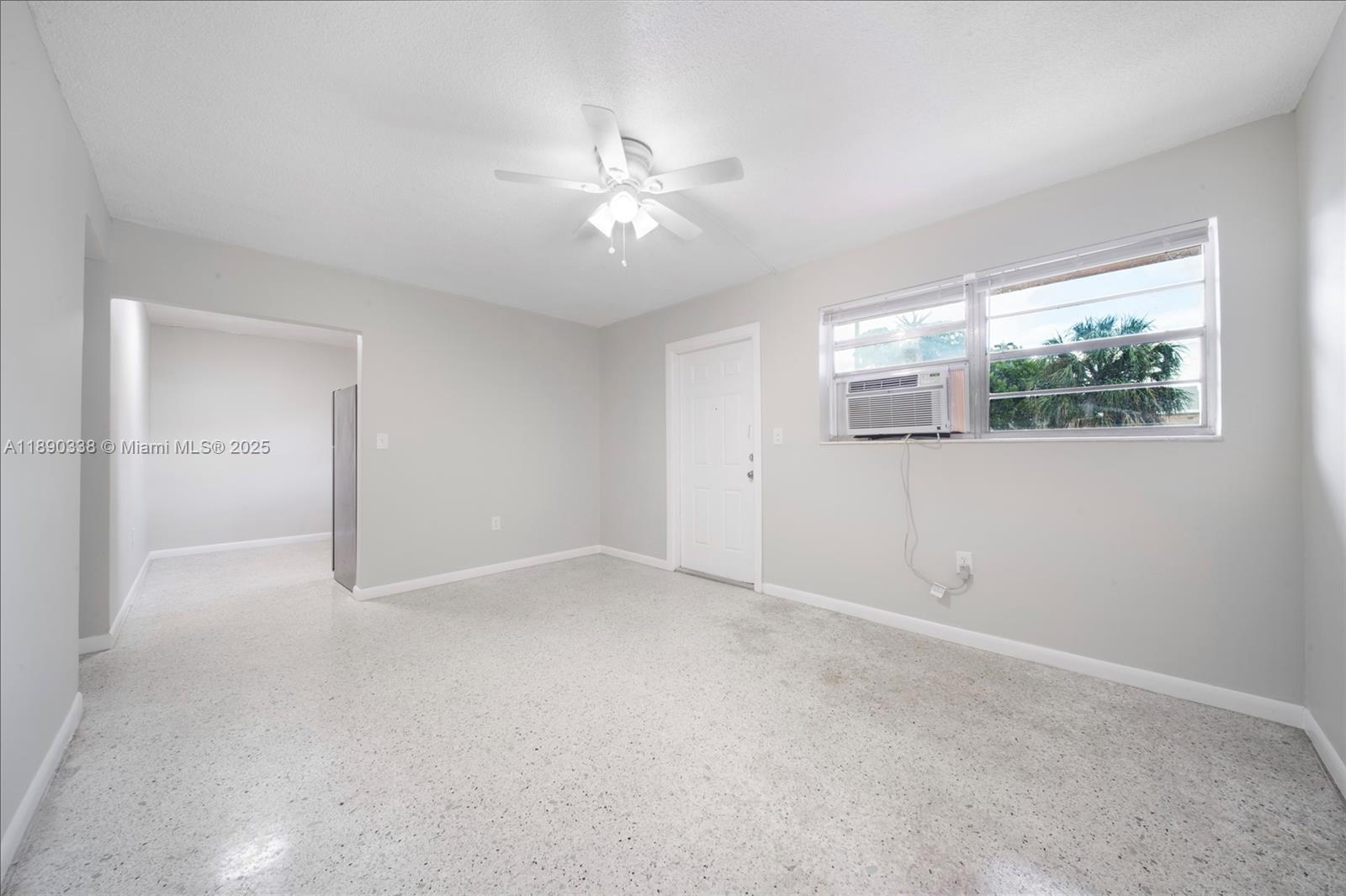 40 West 4th Street, Unit 2 Hialeah, FL 33010 - Photo 27 of 44 an empty room with windows and chandelier fan