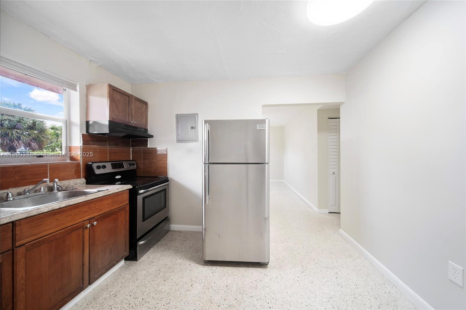 40 West 4th Street, Unit 2 Hialeah, FL 33010 - Photo 29 of 44 a kitchen with a refrigerator stove and microwave