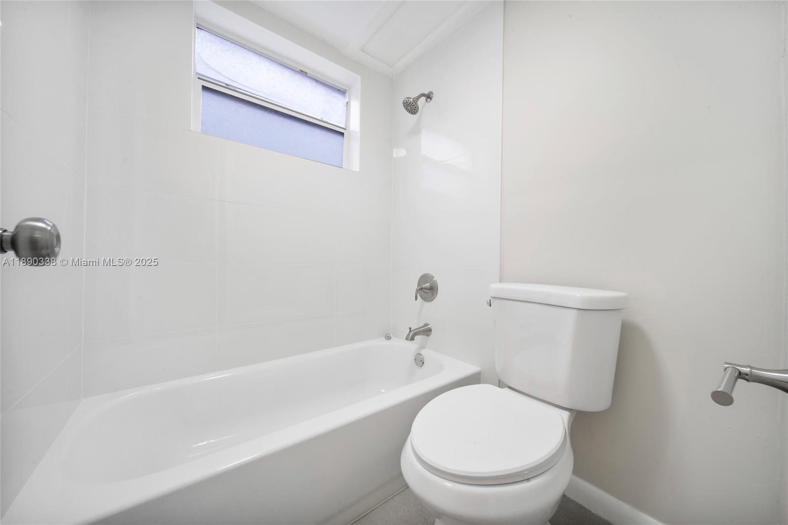 40 West 4th Street, Unit 2 Hialeah, FL 33010 - Photo 33 of 44 a white toilet sitting next to a bath tub