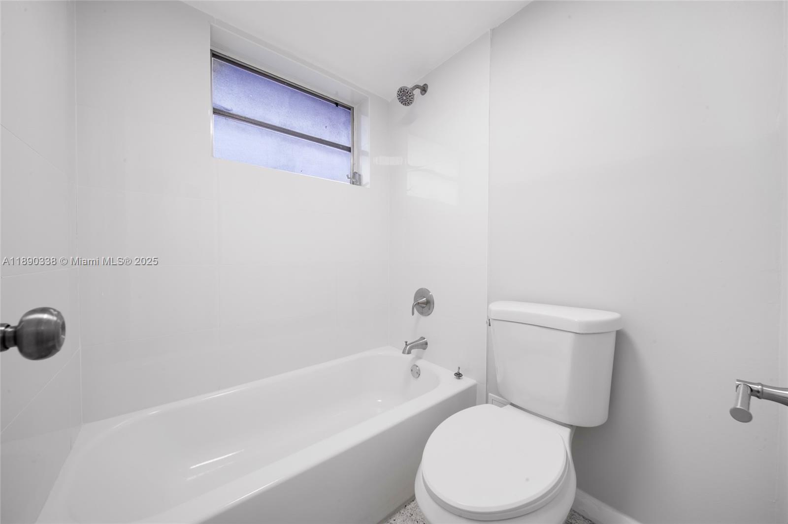 40 West 4th Street, Unit 2 Hialeah, FL 33010 - Photo 44 of 44 a white toilet sitting next to a bath tub