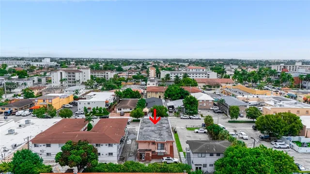 an aerial view of residential houses with green space
