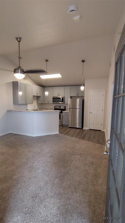 6108 Abrams Road, Unit 522 Dallas, TX 75231 - Photo 11 of 14 Kitchen featuring refrigerator, range, dark colored carpet, a peninsula, and baseboards