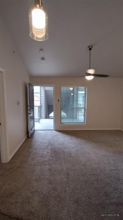 6108 Abrams Road, Unit 522 Dallas, TX 75231 - Photo 3 of 14 Unfurnished room with carpet flooring, a ceiling fan, baseboards, and lofted ceiling