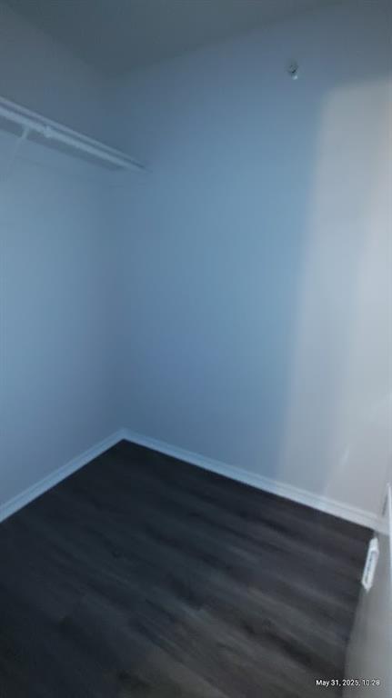 6108 Abrams Road, Unit 522 Dallas, TX 75231 - Photo 10 of 14 Walk in closet featuring dark wood-style floors