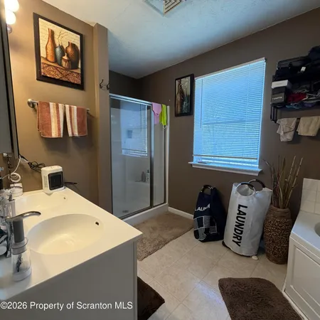 a bathroom with a sink a mirror and shower