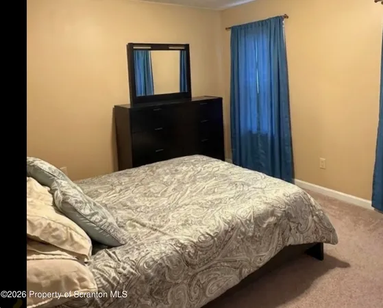 a bed sitting in a bedroom with a mirror