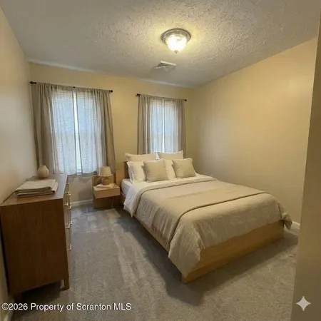 a bedroom with a bed and a television