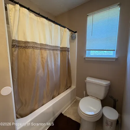 a bathroom with a toilet a sink and a shower