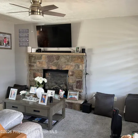 a living room with furniture and a fireplace