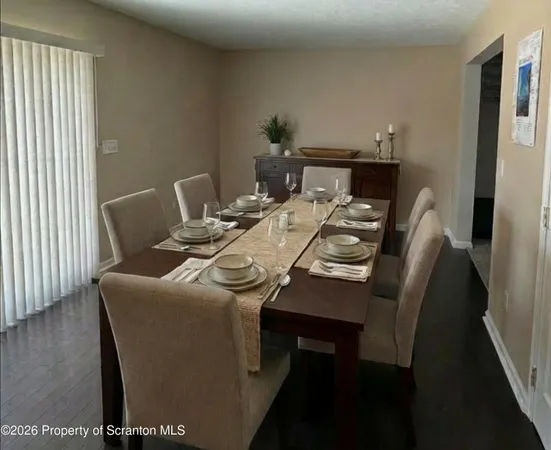 a dining room with furniture and wooden floor