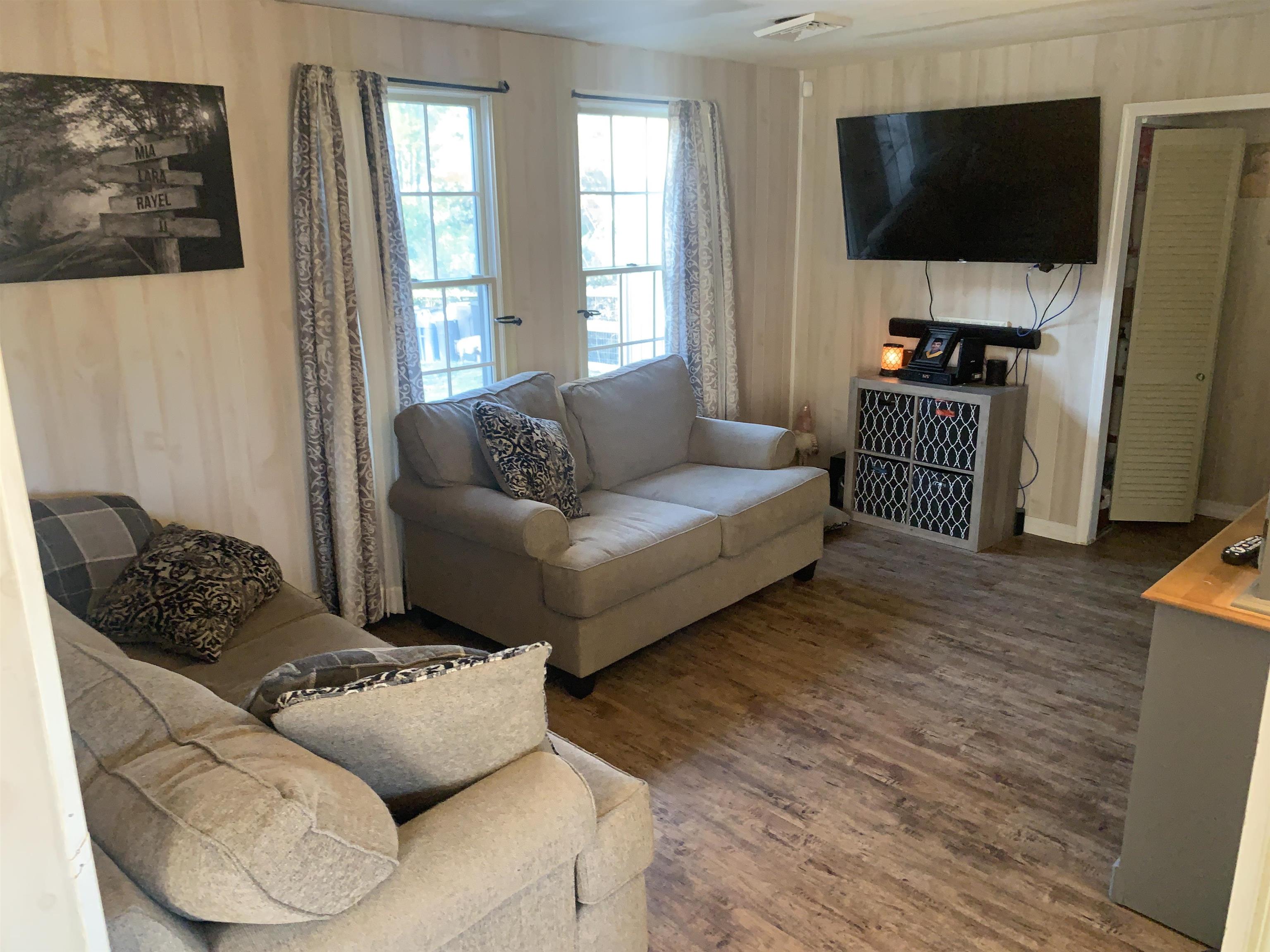 7 School Rio Grande, NJ 08242 - Photo 2 of 13 a living room with furniture and a flat screen tv