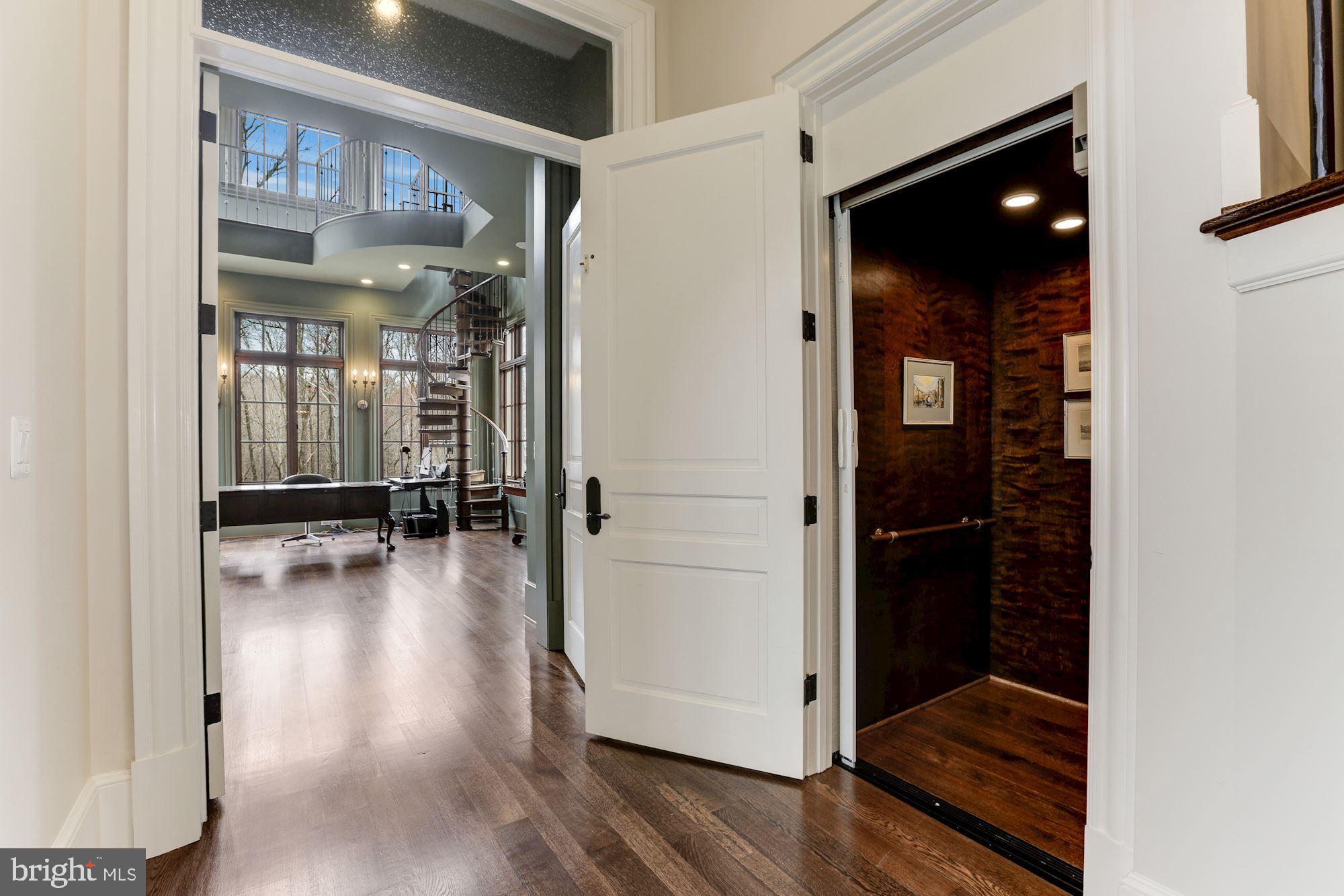 906 Turkey Run Road McLean, VA 22101 - Photo 12 of 52 a view of a hallway with wooden floor and living room