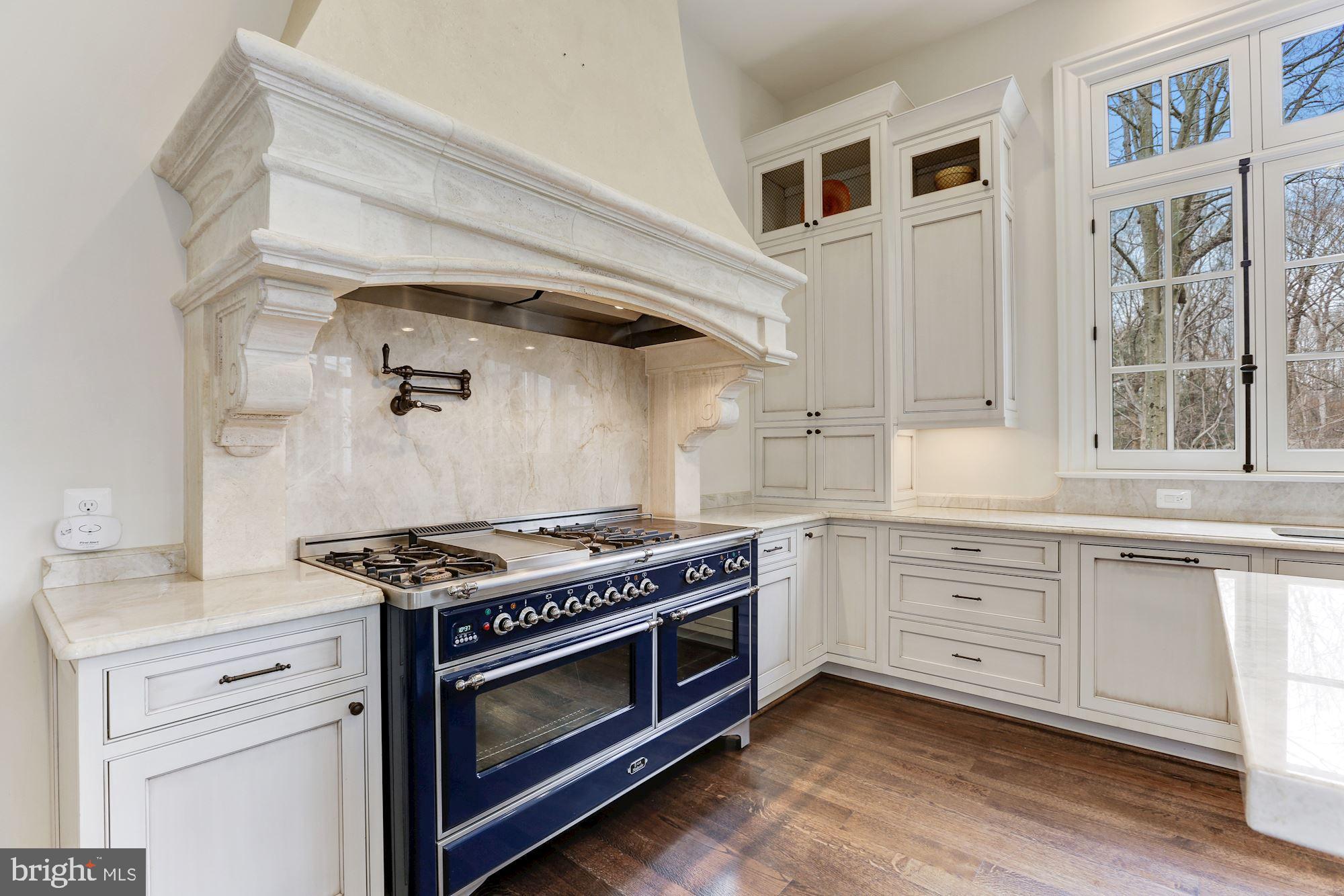 906 Turkey Run Road McLean, VA 22101 - Photo 18 of 52 a kitchen with stainless steel appliances granite countertop a stove and a sink
