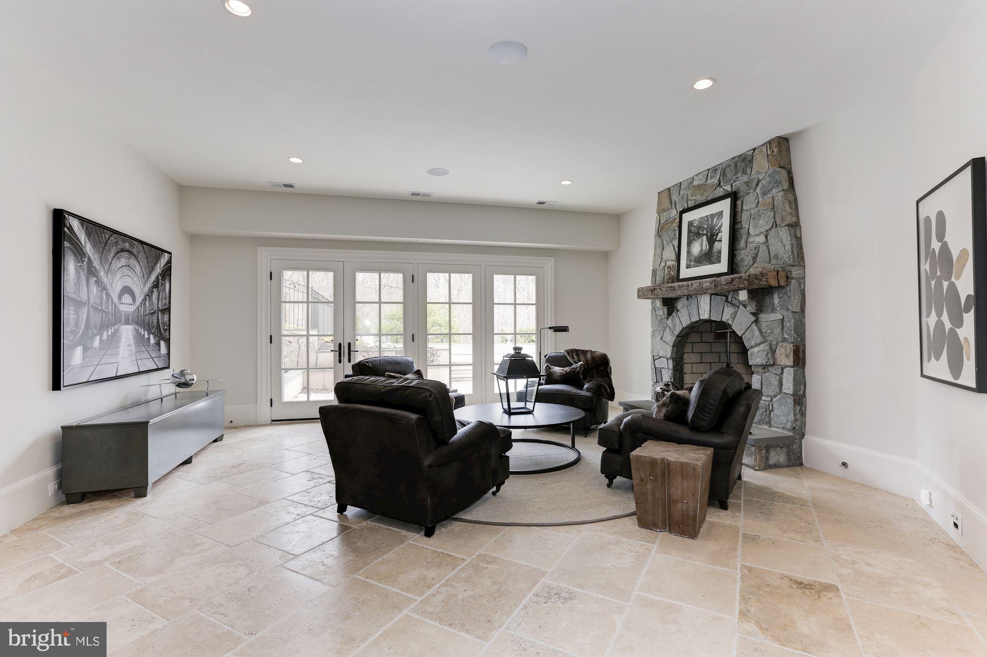 906 Turkey Run Road McLean, VA 22101 - Photo 38 of 52 a living room with furniture a fireplace and a large window